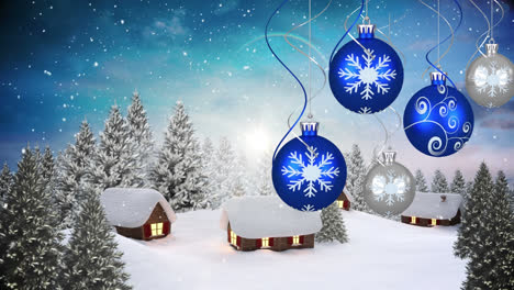 Animation-of-christmas-baubles-and-snow-falling-over-winter-landscape