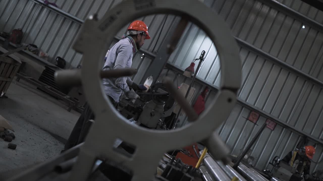 slow motion India metallurgy factory workers wearing helmet works in production manufacturing line during night shift