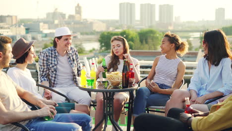 friends enjoying rooftop party with city view