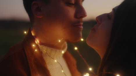 couple with fairy lights kissing