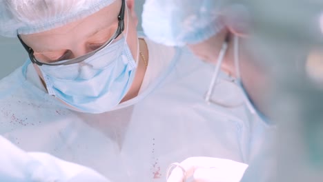 a surgeon in a sterile operating room performing a surgical procedure with focus and precision. represents healthcare, surgery, medical expertise, and patient care