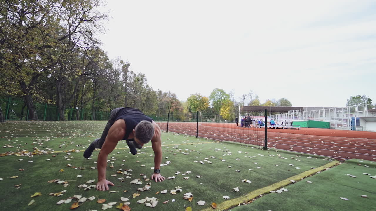 Man training at stadium. Male with muscular fit and slim body at the city stadium