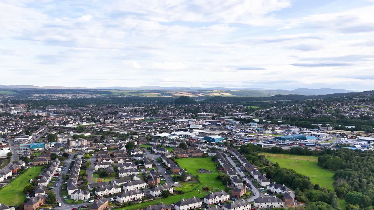 Wide aerial shot of Dundee’s residential area, steady drone movement, soft daylight, expansive sky