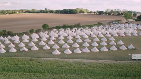 Drone-aerial-wide-shot-of-bell-tents-at-campsite
