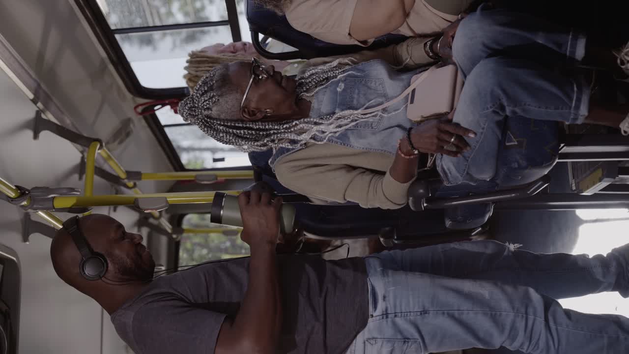 People commuting and interacting on a public transport bus