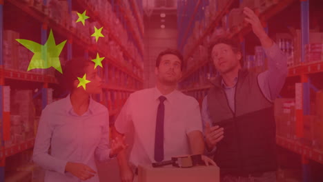 animation of flag of china over diverse male and female colleagues discussing in warehouse