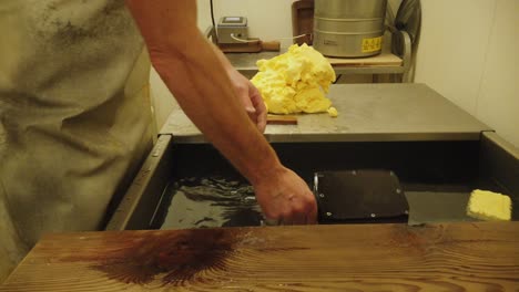 close up of a man at work making butter in a dairy