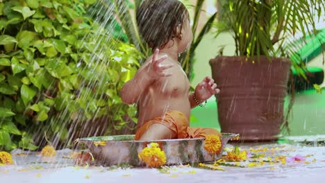 cute toddler baby boy bathing in decorated bathtub at outdoor from unique perspective