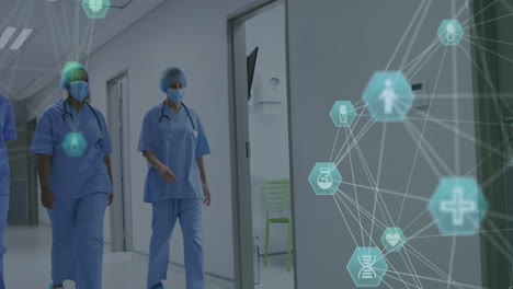 animation of networks of connections with icons over diverse doctors wearing face masks
