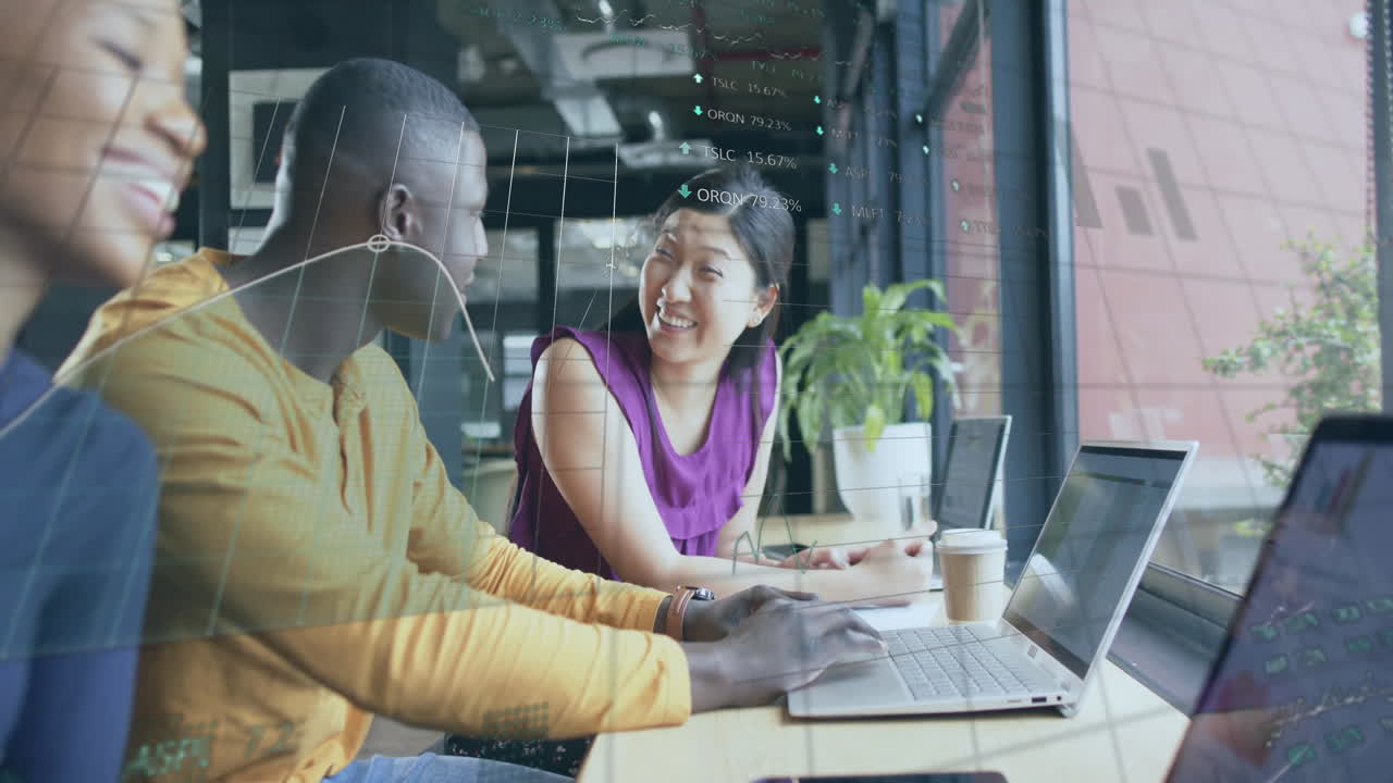 Animation of financial data processing over diverse businesspeople using laptops in office