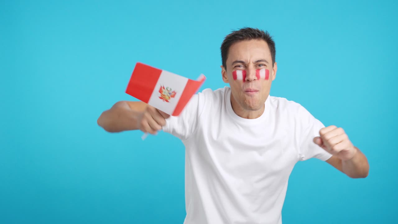 Man cheering for Peru screaming and waving a national flag