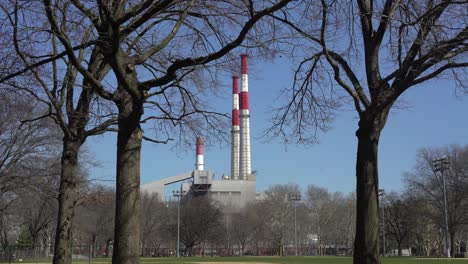 smokestacks behind the park and through the trees