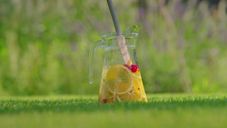 summer fruit infused iced tea in a glass pitcher