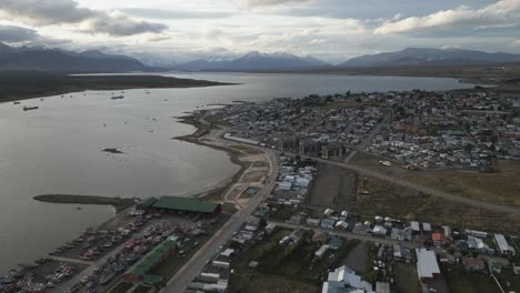 pacific waters of gulf montt, puerto natales chile, antarctic patagonia aerial view, drone fly above sailing port, and city buildings