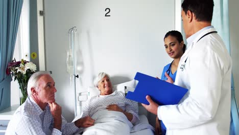 doctor discussing report with senior couple