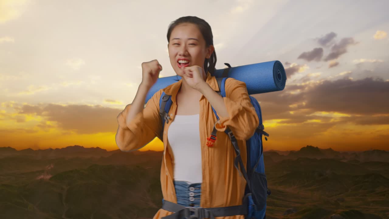 Asian Female Hiker With Mountaineering Backpack Enjoy Dancing On The Top Of Mountain During Sunset Time