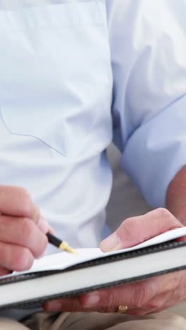 close up view of a therapist man taking notes