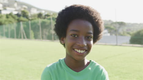 a biracial boy smiles brightly outdoors, with copy space