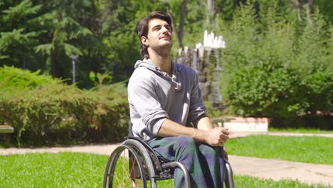 un joven con discapacidad física feliz en la calle, en el parque.
