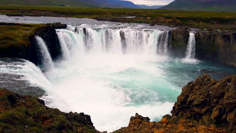 Majestic,-crystal-clear-12-meter-39-feet-high-Godafoss-Waterfall-in-the-river-Skjálfandafljót-in-northern-Iceland,-wide-static-from-above,-4k-ProRezHQ