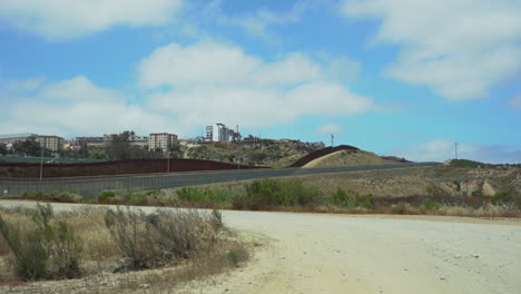 the international border between usa and mexico showing a double fence
