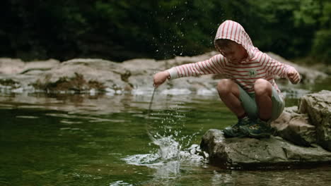 boy playing in a creek