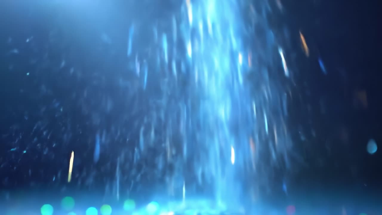 A dynamic light show features colorful lights cascading through water droplets, creating a mesmerizing atmosphere in an urban environment. Viewers enjoy the spectacle from various angles.