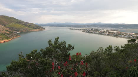 a beautiful summers day overlooking the knysna heads from a viewpoint with boats coming in and out of the indian ocean