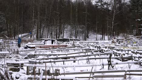 sustainable community farm garden in snowy winter, zoom out, wide