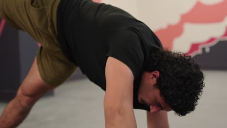 man practicing yoga poses, close up