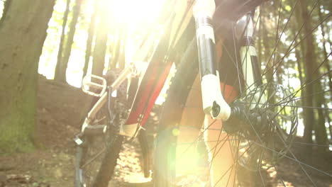 close up of man on mountain bike in woodland