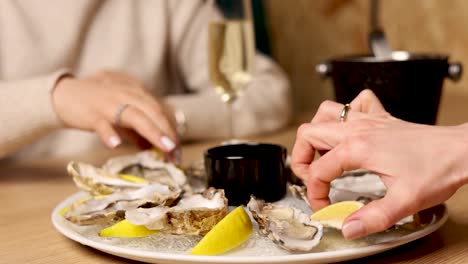 woman eating oysters at a restaurant