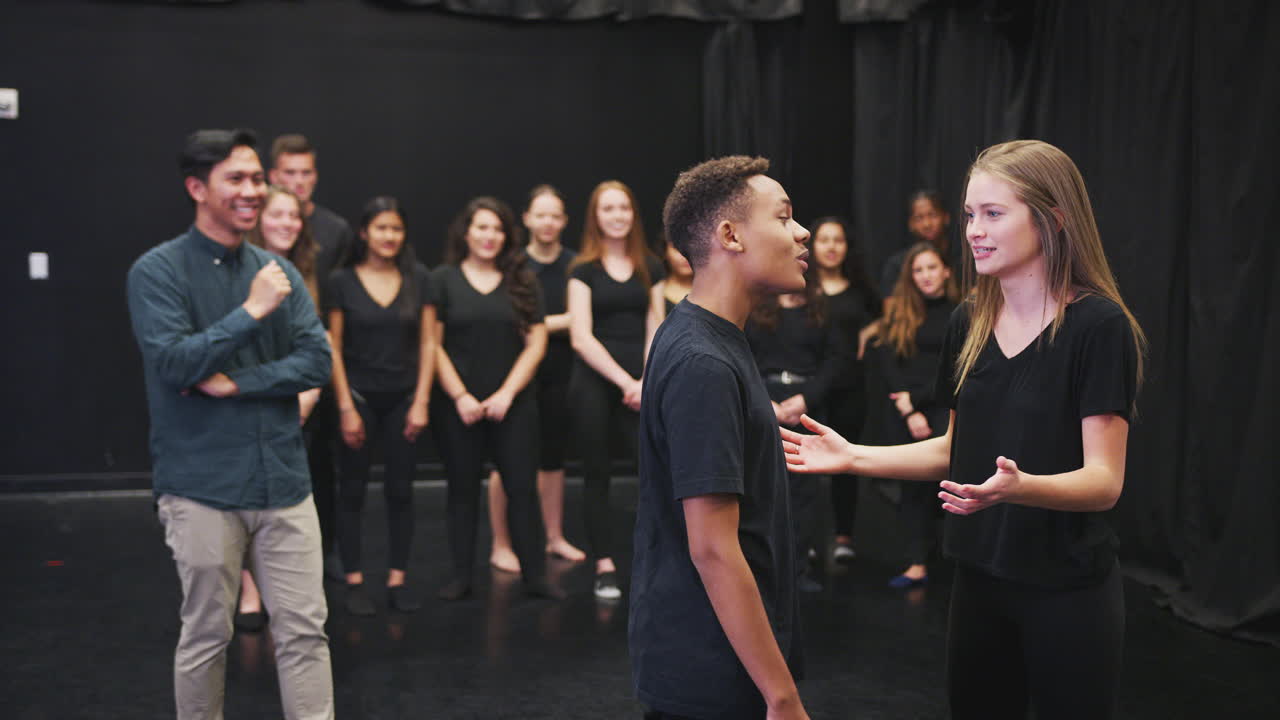 maestro con estudiantes de teatro en la escuela de artes escénicas en la clase de improvisación de estudio