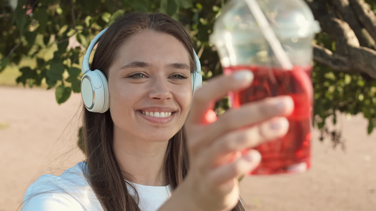 Woman Looking at Soda Cup