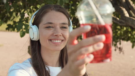 woman looking at soda cup