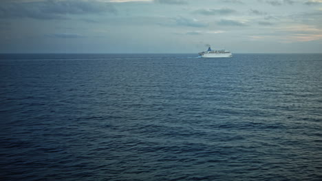 cruise ship in ocean with small waves and in a distance