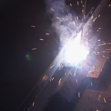 welder uses torch to make sparks