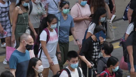 hong kong - june 29, 2020: slow motion of crowd people wearing medical face masks in hong kong. coronavirus concept.