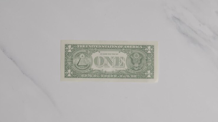 Overhead Currency Shot Of Hand Grabbing US 1 Dollar Bill On Marble Surface
