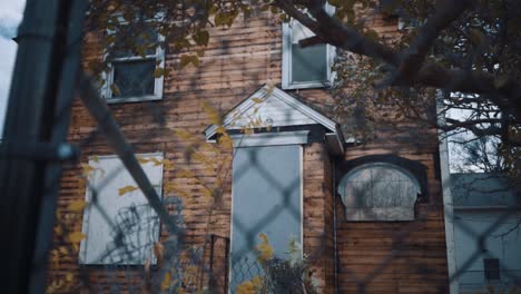 Boarded-up-house-through-fence