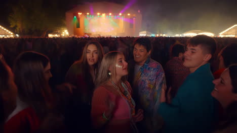 group of friends enjoying a music concert at night