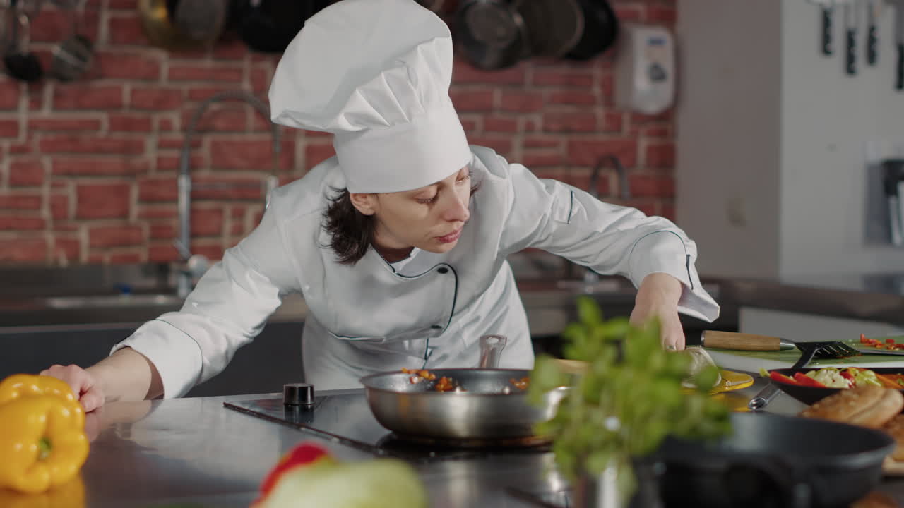 Female chef cooking traditional meal with grated cheese