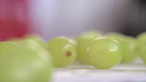 close on green grapes poured onto chopping board