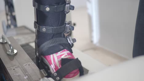 patient's foot in ankle brace during physical therapy session