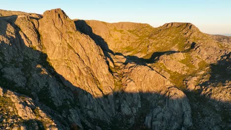 Dramatic-Cântaros-Serra-da-Estrela-mountainous-terrain-lit-up-at-sunrise,-aerial