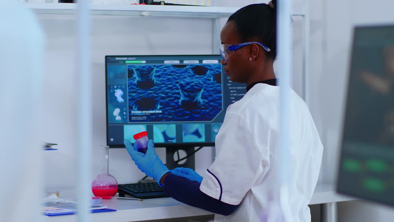 Black chemist checking blood samples
