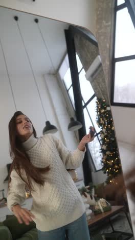 woman getting ready in front of a mirror during christmas season.