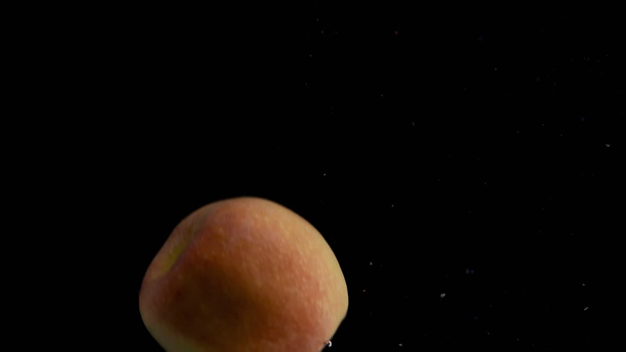 manzana cayendo al agua en cámara superlenta, fondo negro, muchas burbujas de aire, 4k240fps