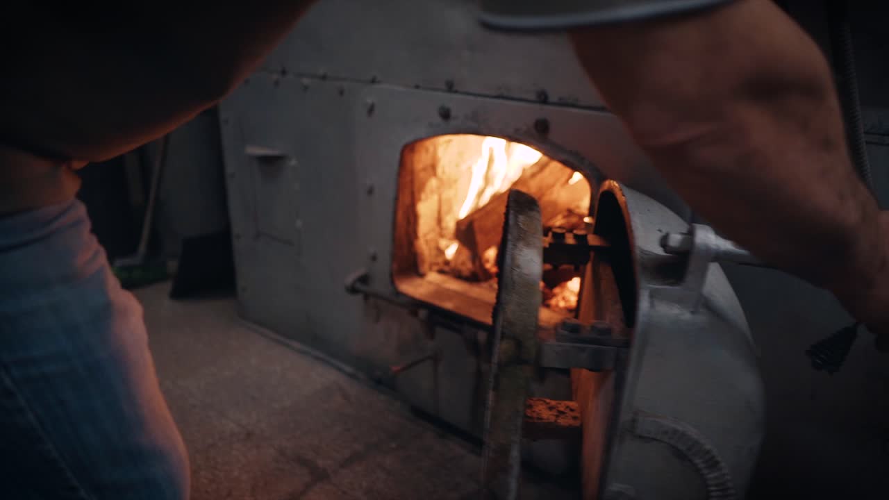 Coffee Roasting Process - Probat coffee roasting machine furnace being filled with wood.