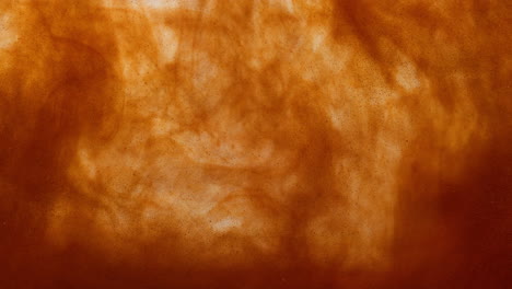 golden-liquid-smoke-filled-with-particles,-epic-orange-abstract-paint-dye-visual-in-bright-slowmotion